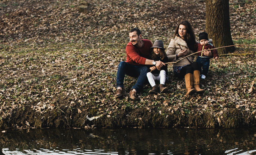family on river bank